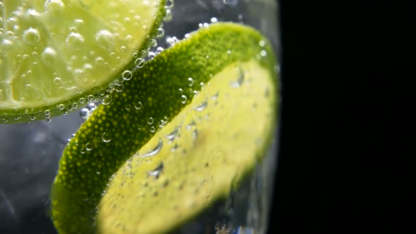 Detox or thirst concept. Healthy, dietary nutrition. Cold lemonade, lime drink. Black background — Stock Video