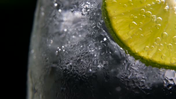 Detox or thirst concept. Healthy, dietary nutrition. Cold lemonade, lime drink. Black background — Stock Video