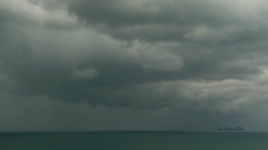 Turkuaz deniz üzerinde karanlık fırtına bulutları ile dramatik kasvetli gökyüzü. Okyanus Ufukta fırtına. Canlı hava timelapse güzel bir deniz manzarası yağmur fırtınası görüntülemek. Tropikal yağmur sezonu tayfun hava