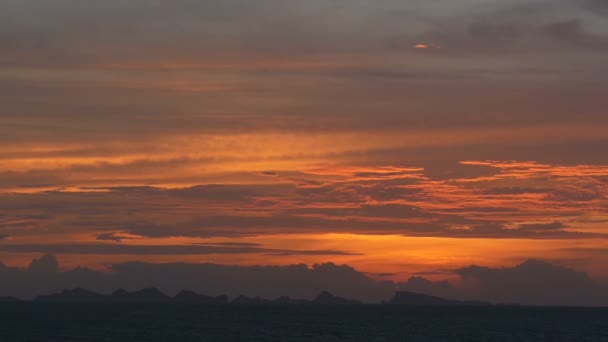 Majestic tropical orange summer timelapse sunset over sea with mountains silhouettes. Aerial view of dramatic twilight, golden cloudy sky over islands in ocean. Vivid dusk seascape natural background — Stock Video