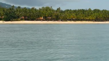 Sandy beach küçük geleneksel Tay tarzında kulübe ve sakin okyanus, Koh Samui Adası, Tayland ile. Yeşil Hindistan cevizi avuç içi kıyı ve dağ arkasında. Pastoral tropikal egzotik cennet waterscape,