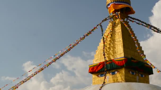 Colorful prayer flags flying in the wind at Boudhanath Stupa, Holy Pagoda, symbol of Nepal and Kathmandu with golgen Buddhas Eyes. sunset ligth
