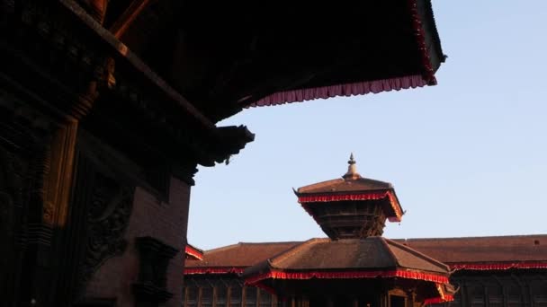 Beautiful old architecture of royal Durbar square. Exterior of temple buildings on Durbar square in bright sunlight under blue sky. oriental ancient city after earthquake — Stock Video