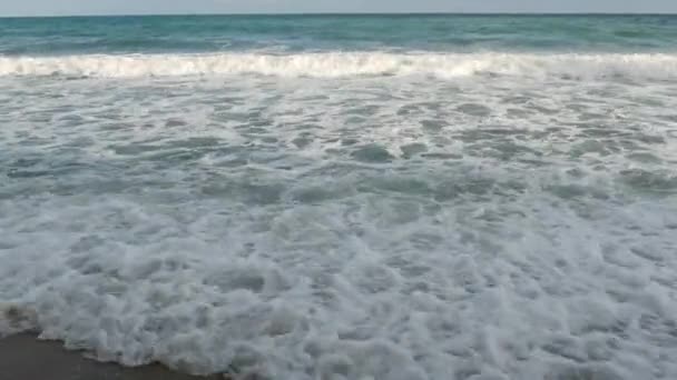 Vagues de mer mousseuses près du rivage. Vagues mousseuses de la mer magnifique roulant près de la côte humide dans la nature merveilleuse . — Video