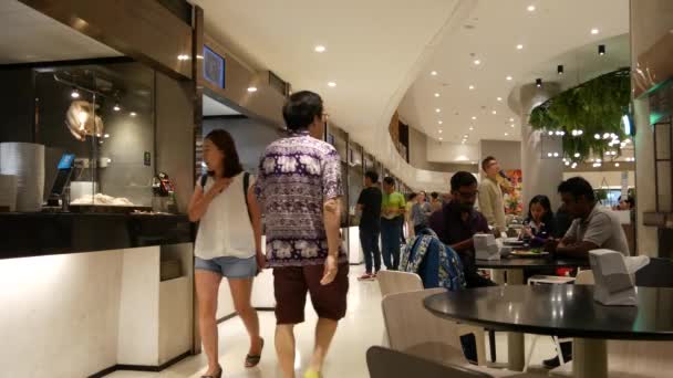 BANGKOK, THAILAND - 18 DECEMBER, 2018: People eating and bying asian thai street fast food in the food court at cafeteria in shopping mall in business centre of city — Stock Video