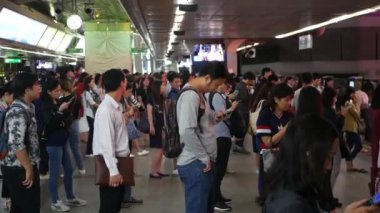 BANGKOK, THAILAND - 18 ARALIK 2018: BTS Skytrain İstasyonu yolcusu, Bangkok Tayland 'daki herkes BTS hava trenini beklerken akıllı telefona bakıyor