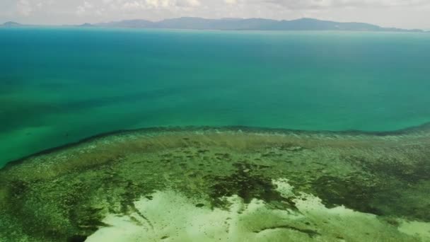 素晴らしいサンゴ礁の眺め。熱帯の島の海岸近くの静かな青い海と美しいサンゴ礁の絵のように美しいドローンビュー。パラダイス環礁 — ストック動画