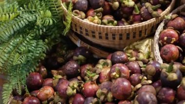 Meyve ve sebzeler köy tezgahında. Marketteki kırsal kesimlere yerleştirilmiş taze meyve ve sebzeler. Tatlı tropik mor mangosteen. Tayland 'da meyvelerin kraliçesi.