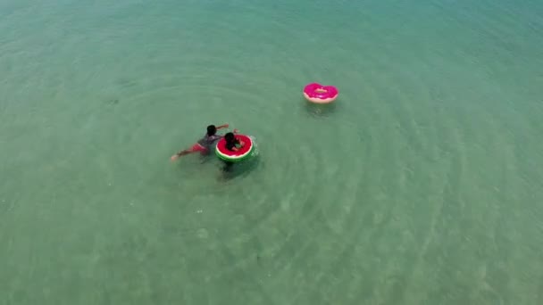 KOH SAMUI, THAILAND - 8 MAY 2019. Chaweng beach. Kids swimming on tubes in sea. Two ethnic children having fun while swimming in sea water on inflatable tubes on resort. — Stock Video