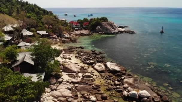 Små hus på tropisk ö. Små mysiga bungalows ligger på stranden av Koh Tao Island nära lugnt hav på solig dag i Thailand. — Stockvideo