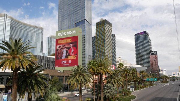 LAS VEGAS, NEVADA USA - 7 MAR 2020: The Strip boulevard with luxury casino and hotels, gambling sin city. Car traffic on road to Fremont street in tourist money playing resort. Futuristic CityCenter.
