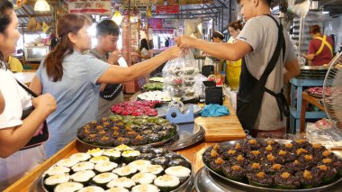 BANGKOK, THAILAND - 13 Temmuz 2019: Lat Mayom khlong nehir kanalı geleneksel yüzen pazar. İkonik yerel Asya sokak yemekleri satıyor. Tezgahlarda egzotik mallarla satıcı ve alıcılar.