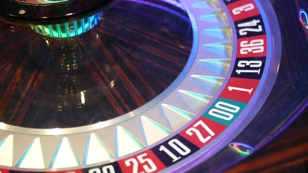 French style roulette table for money playing in Las Vegas, USA. Spinning wheel with black and red sectors for risk game of chance. Hazard amusement with random algorithm, gambling and betting symbol.