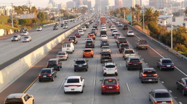 SAN DIEGO, CALIFORNIA USA - 15 HAZİRAN 2020: yoğun şehirlerarası otoyol, yoğun saatlerde otoyolda trafik sıkışıklığı. Şehir silüeti ve gökdelenler. Metropolis 'te ulaşım kavramı ve taşımacılık.
