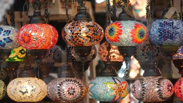 Colourful turkish lamps from glass mosaic glowing. Arabic multi colored authentic retro style lights. Many illuminated moroccan craft lanterns. Oriental islamic middle eastern decor. Shiny folk shop — Stock Video