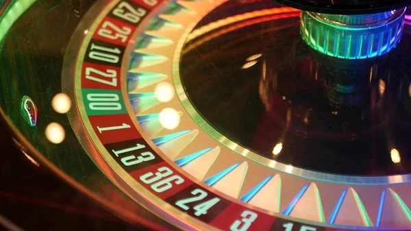 French style roulette table for money playing in Las Vegas, USA. Spinning wheel with black and red sectors for risk game of chance. Hazard amusement with random algorithm, gambling and betting symbol.