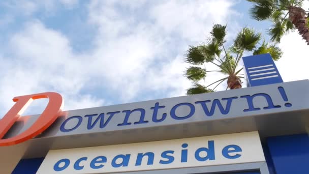 Havet namnskylt och palmer. Oside är den populära amerikanska turistort, Stilla havet västkusten, San Diego County, Kalifornien USA. Namn på stad för semestrar och turism vid kusten — Stockvideo