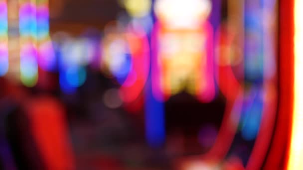 Defocused slot machines glow in casino on fabulous Las Vegas Strip, USA. Blurred gambling jackpot slots in hotel near Fremont street. Illuminated neon fruit machine for risk money playing and betting — Stock Video