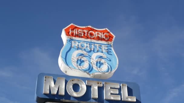 Motel retro sign on historic route 66 famous travel destination, vintage symbol of road trip in USA. Iconic lodging signboard in Arizona desert. Old-fashioned neon signage. Classic tourist landmark — Stock Video