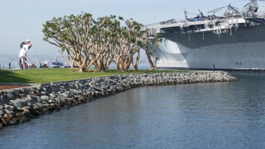 SAN DIEGO, CALIFORNIA USA - 15 HAZİRAN 2020: USS Midway askeri uçak gemisi, tarihi savaş gemisi. Donanma savaş gemisi. Denizcilik savaş gemisi, Donanma filosu efsanesi Koşulsuz Teslimiyet Heykeli yakınlarında..