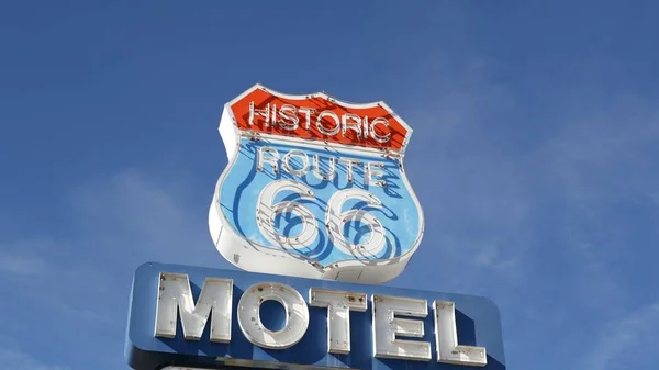 Motel retro sign on historic route 66 famous travel destination, vintage symbol of road trip in USA. Iconic lodging signboard in Arizona desert. Old-fashioned neon signage. Classic tourist landmark.