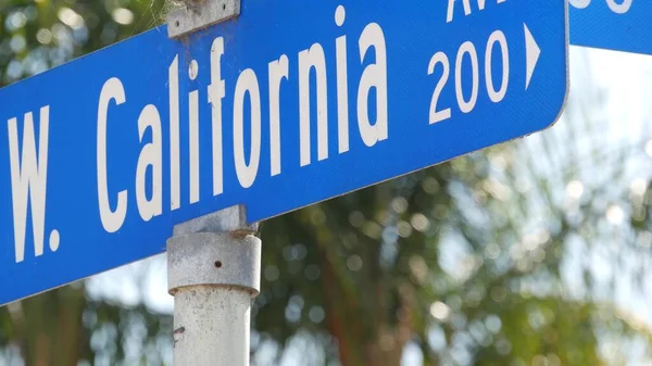 California street road sign on crossroad. Lettering on intersection signpost, symbol of summertime travel and vacations. USA tourist destination. Text on nameboard in city near Los Angeles, route 101.