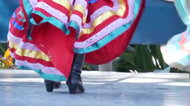 Латиноамериканки в красочных традиционных платьях танцуют Jarabe tapatio, мексиканский народный танец шляпы. Уличное представление женского латиноамериканского балета в разноцветных этнических юбках. Девушки в костюмах — стоковое видео