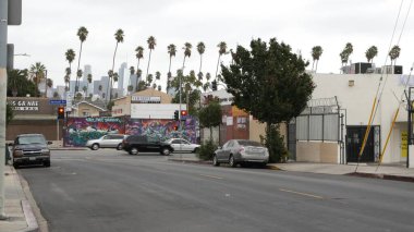 LOS ANGELES, CALIFORNIA, ABD - 27 OCT 2019: Urban skyline and palms. Los Angeles şehri estetiği, Vermont caddesindeki grafiti tablosu. Metropolis 'in merkezindeki gökdelenler. Tipik yol kavşağı.