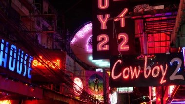 BANGKOK, THAILAND, 13 HAZİRAN 2019: soi Kovboy caddesinde parlayan parlak neon tabelalar. Erotik Red Light bölgesinde gece hayatı. Aydınlatılmış bar ve yetişkin go-go-show kulübü. Gece hayatı turist eğlencesi.