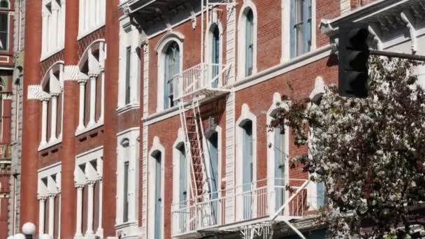 Fire escape ladder outside residential brick building in San Diego city, USA. Typical New York style emergency exit for safe evacuation. Classic retro house exterior as symbol of real estate property — Stock Video