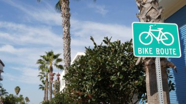 Kaliforniya, ABD 'de bisiklet yolu yeşil yol tabelası. Bisiklet yolu tek direkli. Oceanside Pasifik Turizm Merkezi 'nde bisiklet yolu. Bisiklet levhası ve avuç içi. Sağlıklı yaşam tarzı, eğlence ve güvenlik bisiklet sembolü.