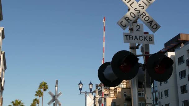 Sinal de alerta de passagem de nível nos EUA. Aviso cruzado e semáforo vermelho na intersecção ferroviária na Califórnia. Símbolo de segurança do transporte ferroviário. Sinal de precaução sobre o perigo e a via férrea — Vídeo de Stock