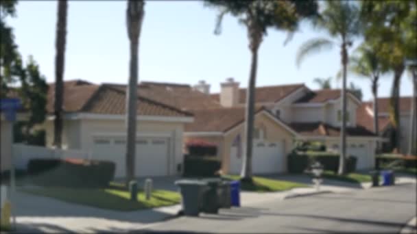 Suburb real estate, property in residential district, San Diego county, California USA. Defocused typical suburban neighborhood. Detached single-family houses, expensive realty. Row of classic homes — Stock Video