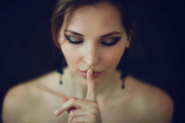 secret woman holding finger on mouth with quiet sign