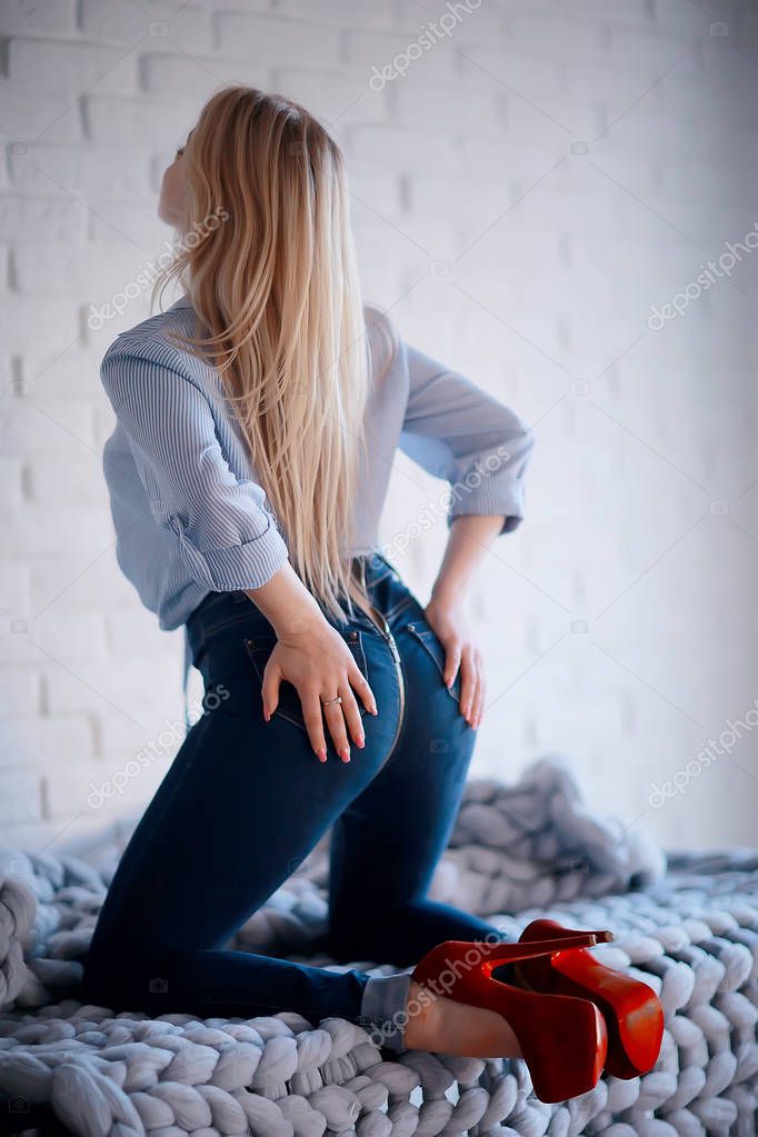 Attraente Giovane Donna Bionda Che Indossa Jeans Scarpe Col Tacco Foto stock di xload 212885640