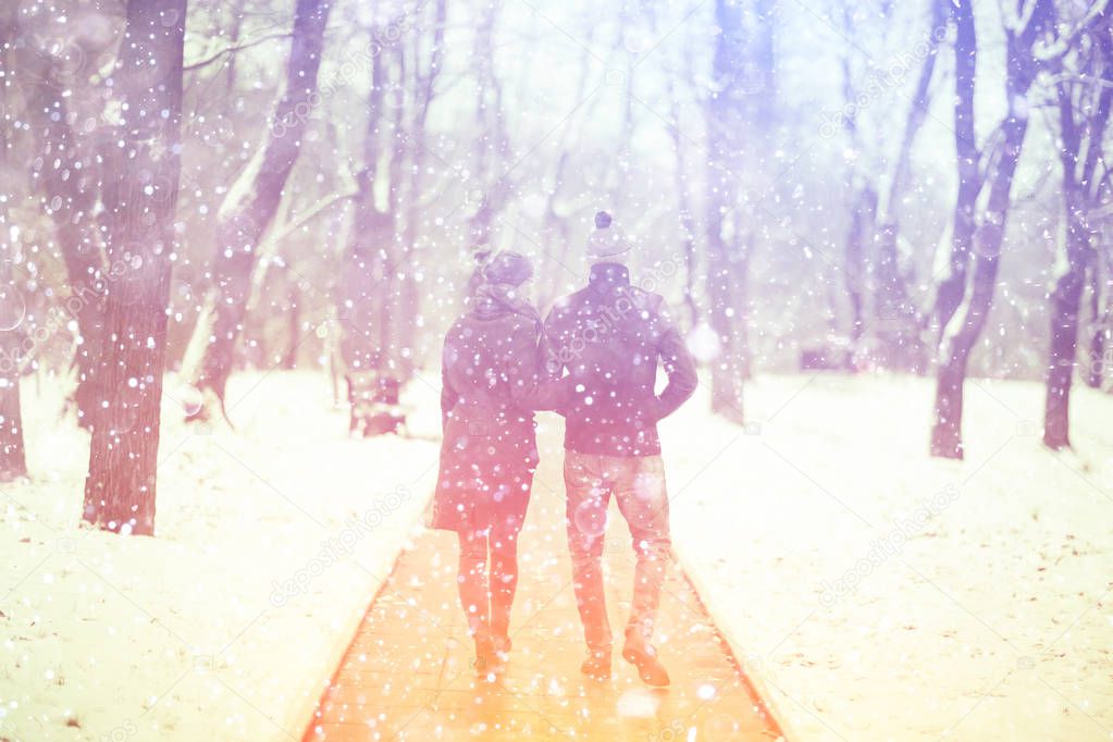 young man and woman walking in winter park, romantic happy couple 