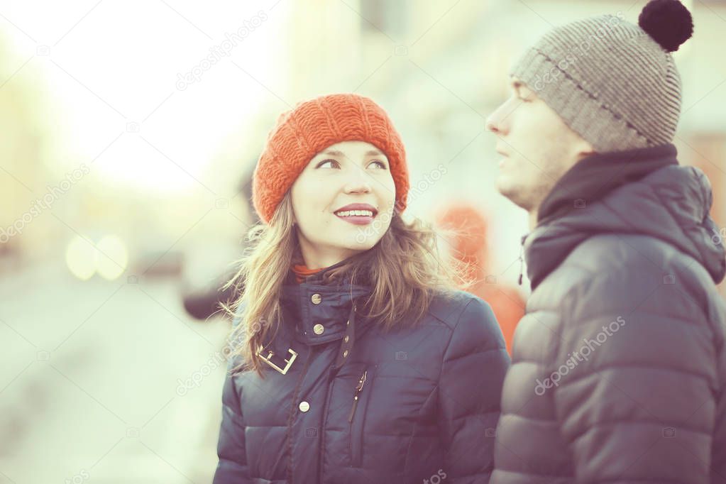 young man and woman walking in winter city, romantic happy couple 