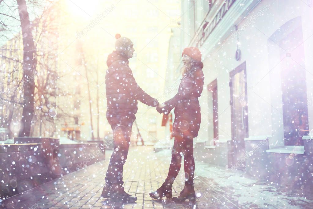 young man and woman walking in winter city, romantic happy couple 