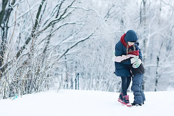 冬の公園で雪と遊ぶ二人の少女 子供の頃 家族の概念 — ストック写真