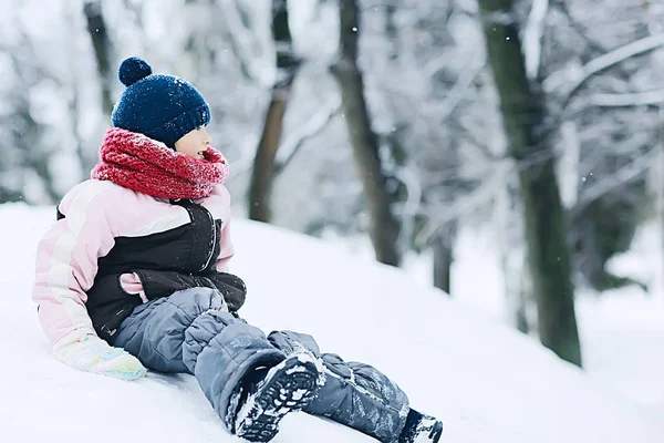 雪に覆われた冬の公園 暖かい服で子供の季節の写真でかわいい女の子 — ストック写真