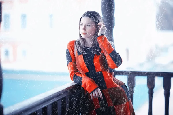 アンティーク木製の欄干に対して格子縞コート ポーズで若い美しい女性 — ストック写真