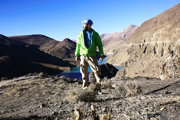 brutal man with backpack,  tourist,  hike, the concept of active recreation. Guy with equipment for mountaineering