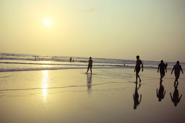 man on sandy beach in India, ocean, coast, vacation concept