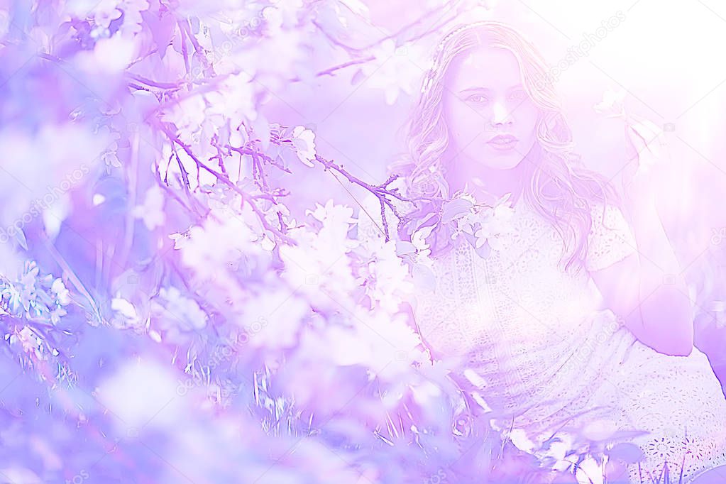 portrait of young beautiful woman with apple tree blossom in spring garden 