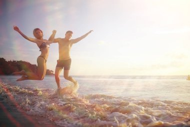 gün batımı, sağlıklı dinlenme, spor aktivite, yaz tatili, plajda atlama sporcuların siluetleri