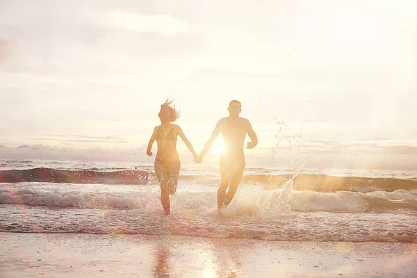 happy love couple running along the beach, healthy rest, sports activity, summer vacation