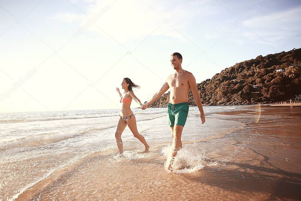 happy love couple running along the beach, healthy rest, sports activity, summer vacation