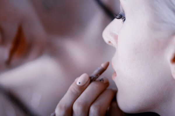 professional make-up in the beauty salon.  Master doing make-up for beautiful model in the salon