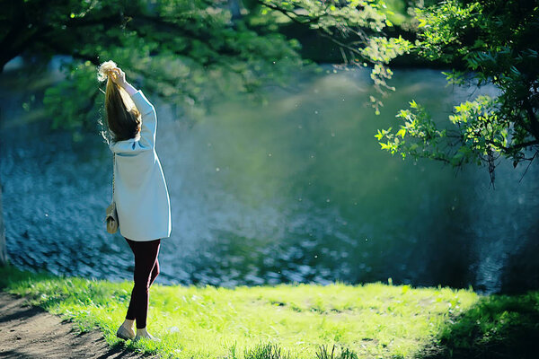 Beautiful blonde woman wearing stylish coat in park