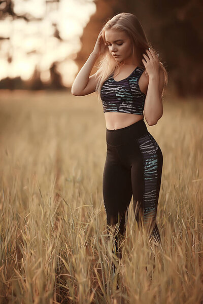 beautiful young woman wearing sportswear in summer park, jogging and sport concept 